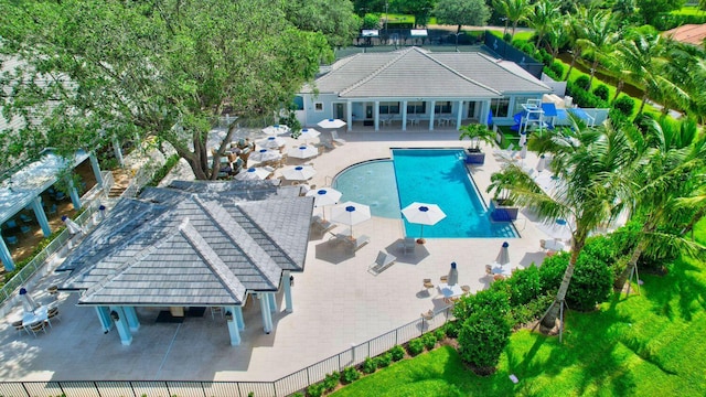 pool with a patio area, a lawn, fence, and a pergola