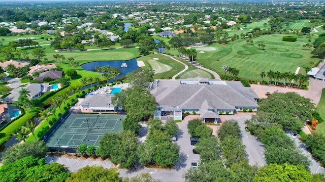 drone / aerial view featuring view of golf course and a water view