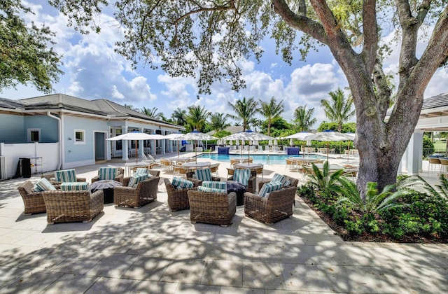 view of patio with an outdoor living space and a community pool