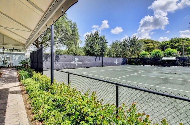 view of tennis court featuring fence