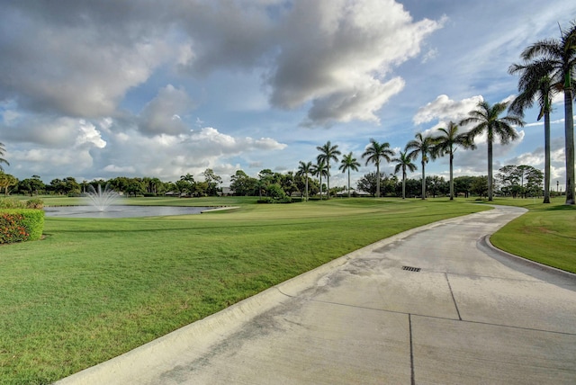 view of home's community featuring a water view and a yard