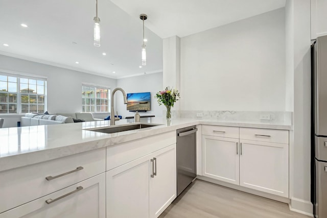 kitchen featuring white cabinetry, pendant lighting, a sink, and recessed lighting