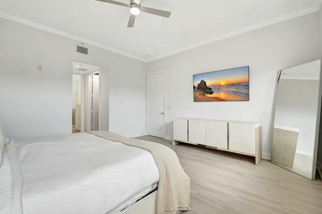 bedroom featuring ornamental molding, visible vents, ceiling fan, and light wood-style flooring