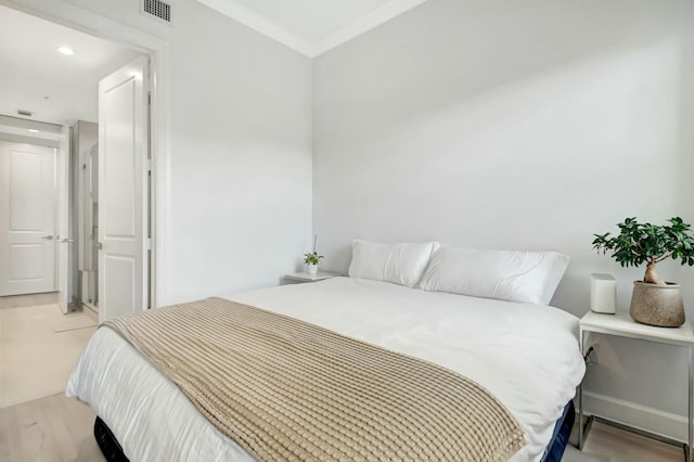 bedroom featuring recessed lighting, visible vents, and crown molding