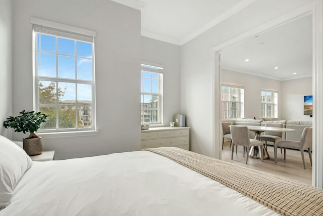 bedroom featuring multiple windows, ornamental molding, wood finished floors, and recessed lighting