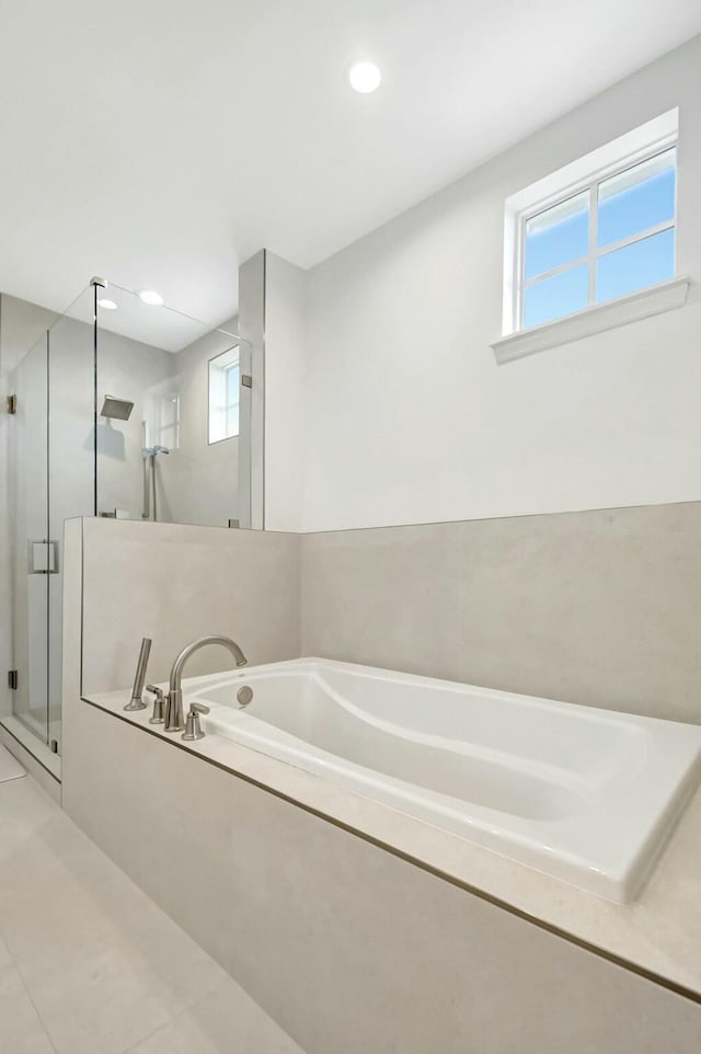 bathroom with recessed lighting, tile patterned flooring, a shower stall, and a bath