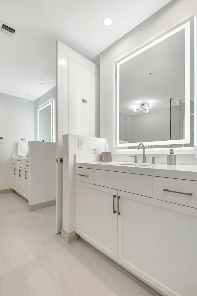 bathroom with recessed lighting, visible vents, and vanity