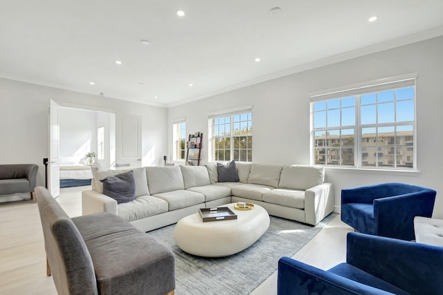 living room featuring crown molding, recessed lighting, and light wood-style floors