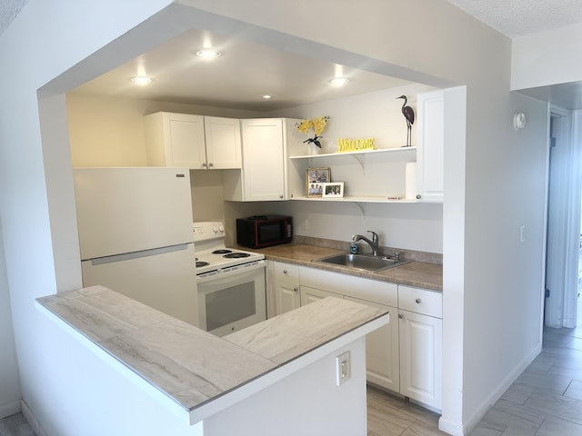 kitchen featuring open shelves, recessed lighting, white cabinets, a sink, and white appliances