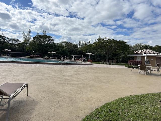 pool featuring a patio area and fence