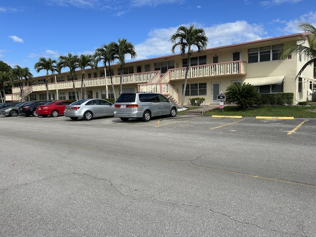 view of building exterior with uncovered parking