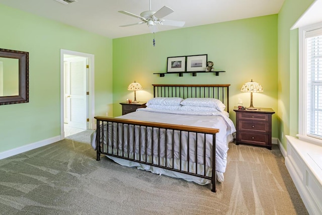 bedroom featuring carpet, multiple windows, and baseboards