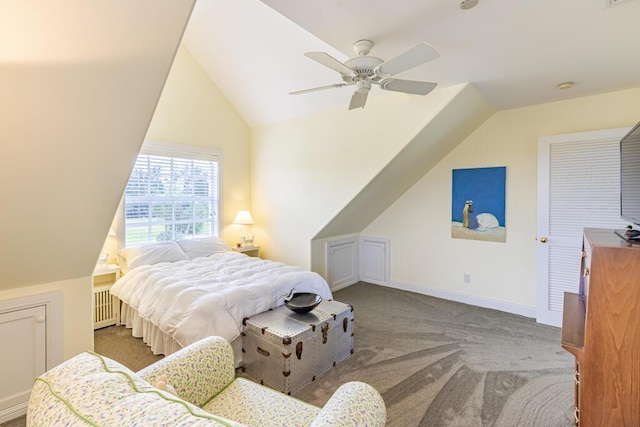 bedroom with radiator heating unit, a ceiling fan, carpet flooring, vaulted ceiling, and baseboards