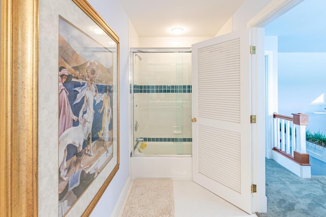 bathroom with bath / shower combo with glass door