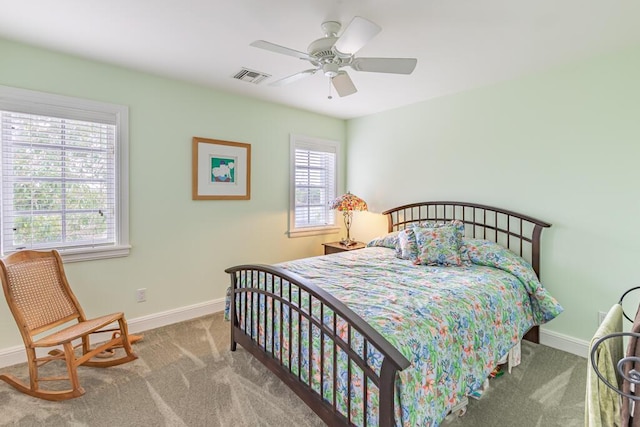 bedroom featuring carpet floors, baseboards, visible vents, and ceiling fan