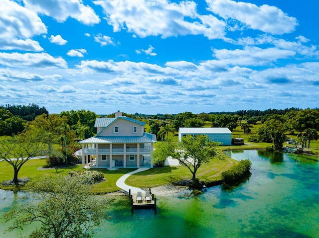 bird's eye view featuring a forest view and a water view