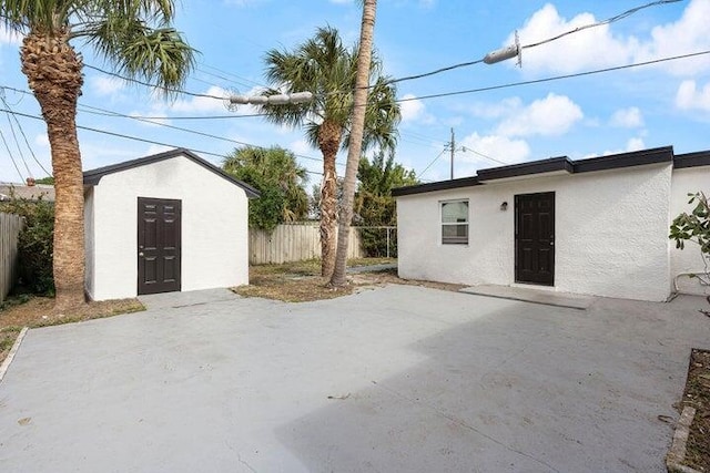 exterior space with an outbuilding and fence