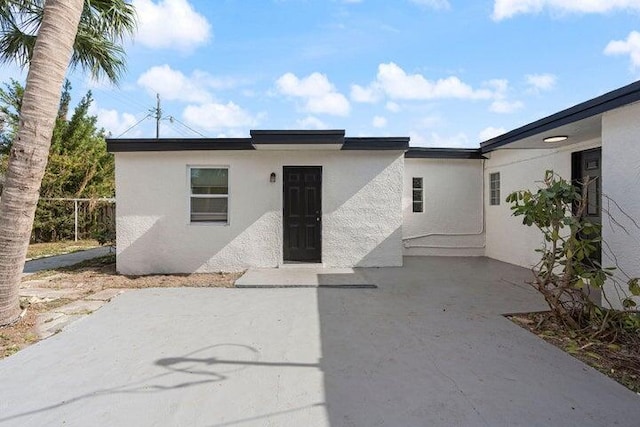 exterior space with a patio area and stucco siding