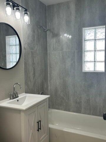 bathroom featuring vanity and bathing tub / shower combination