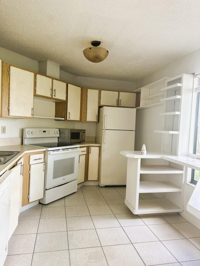 kitchen with white appliances, light tile patterned floors, light countertops, a textured ceiling, and open shelves