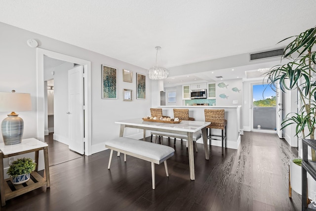 dining space with a chandelier, visible vents, dark wood finished floors, and baseboards