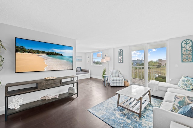 living room featuring a textured ceiling, wood finished floors, and baseboards