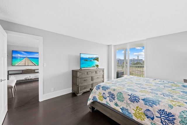 bedroom featuring expansive windows, baseboards, and dark wood finished floors