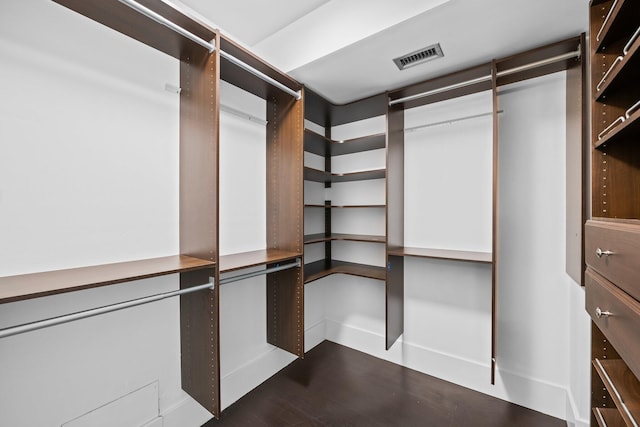 walk in closet with visible vents and wood finished floors