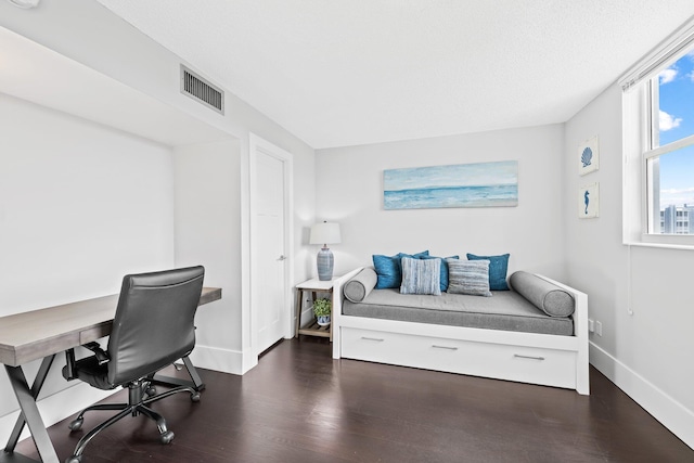 home office with visible vents, baseboards, and wood finished floors