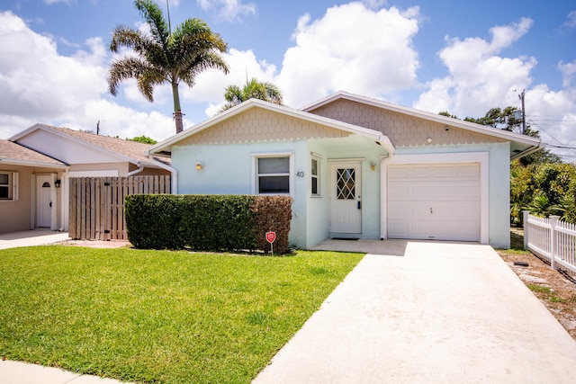 single story home featuring stucco siding, a front lawn, fence, concrete driveway, and a garage