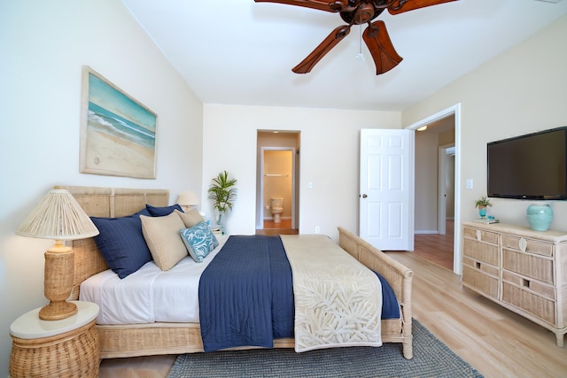 bedroom with light wood-style flooring, connected bathroom, and ceiling fan