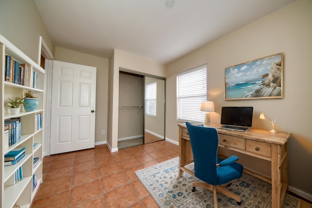 office area featuring light tile patterned floors and baseboards