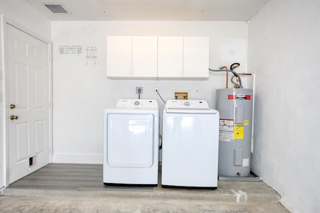 laundry room with baseboards, visible vents, cabinet space, electric water heater, and independent washer and dryer