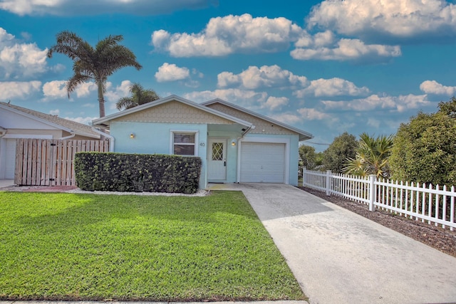 ranch-style house featuring a front yard, fence, stucco siding, concrete driveway, and a garage