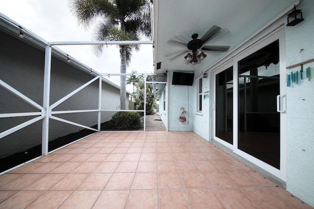 view of patio featuring glass enclosure and ceiling fan