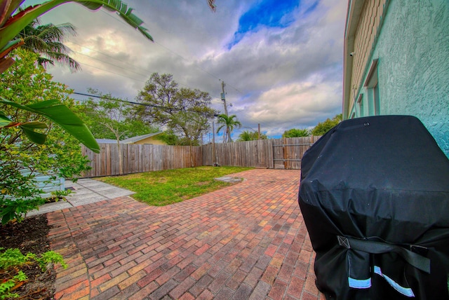 view of patio featuring a grill and a fenced backyard