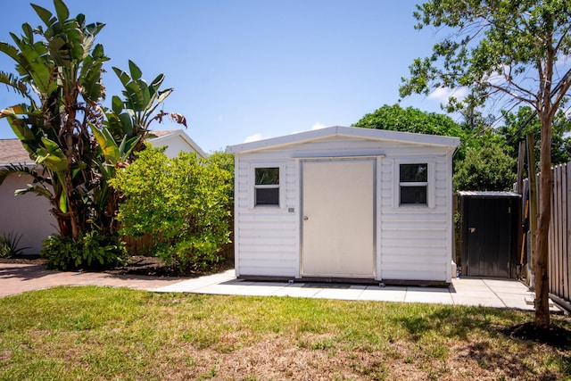 view of shed featuring fence