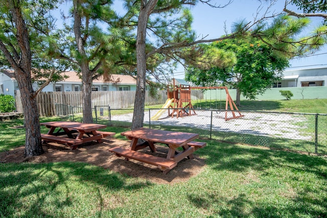 view of yard featuring fence and playground community