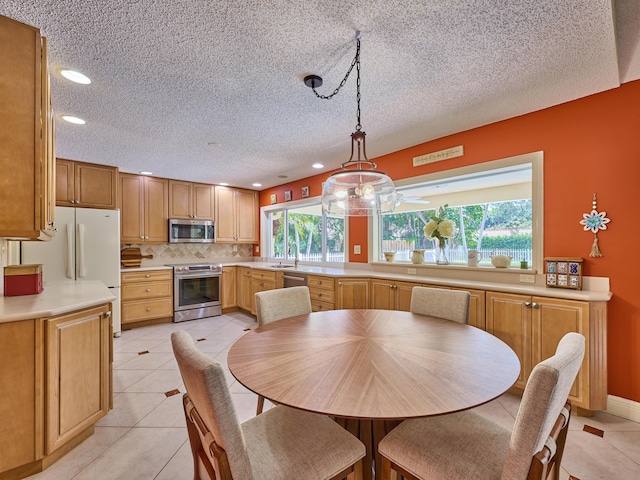 dining room featuring recessed lighting, light tile patterned flooring, and a textured ceiling