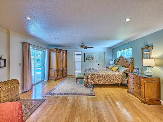 bedroom featuring a textured ceiling, access to outside, light wood-style flooring, and crown molding