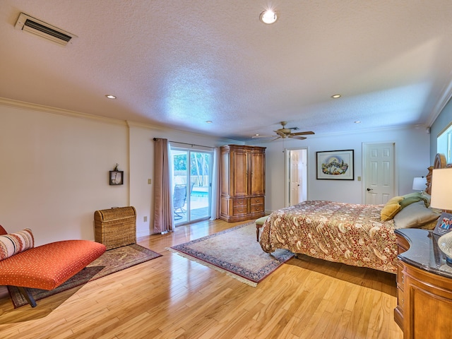 bedroom featuring crown molding, light wood-type flooring, visible vents, and access to exterior