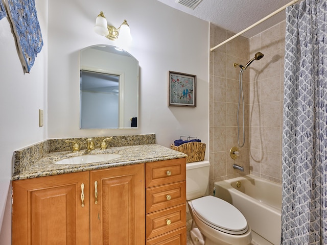 full bath featuring a textured ceiling, shower / tub combo, vanity, and toilet