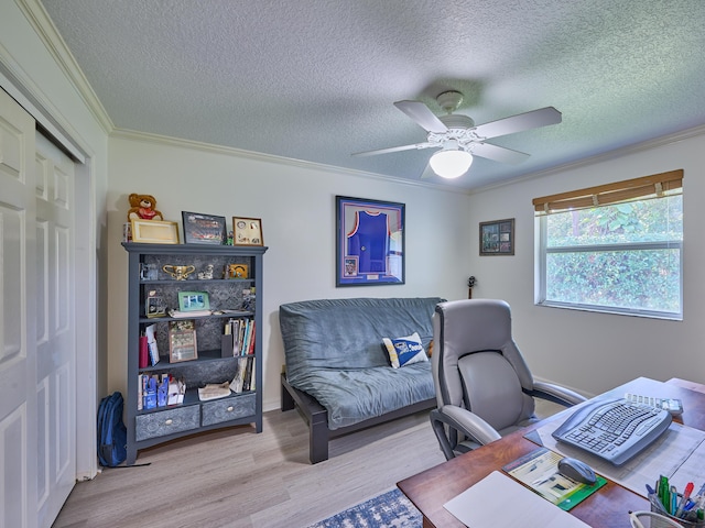 office with a ceiling fan, crown molding, a textured ceiling, and wood finished floors