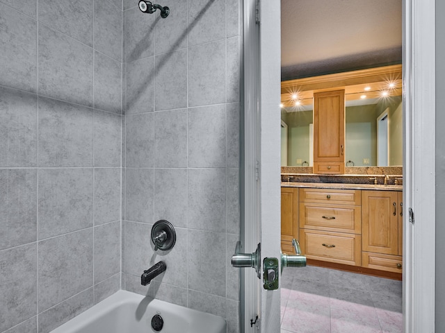 bathroom with double vanity, bathtub / shower combination, and a sink