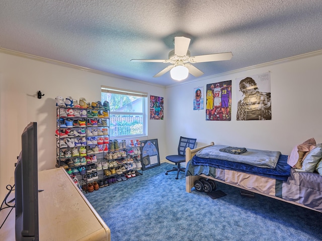 bedroom with ornamental molding, carpet flooring, ceiling fan, and a textured ceiling