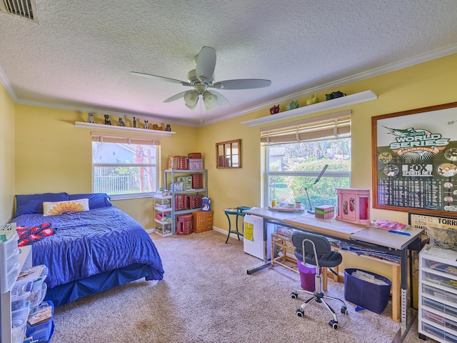 carpeted bedroom with a ceiling fan, a textured ceiling, visible vents, and crown molding