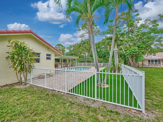 view of yard with a fenced backyard, a fenced in pool, and a patio