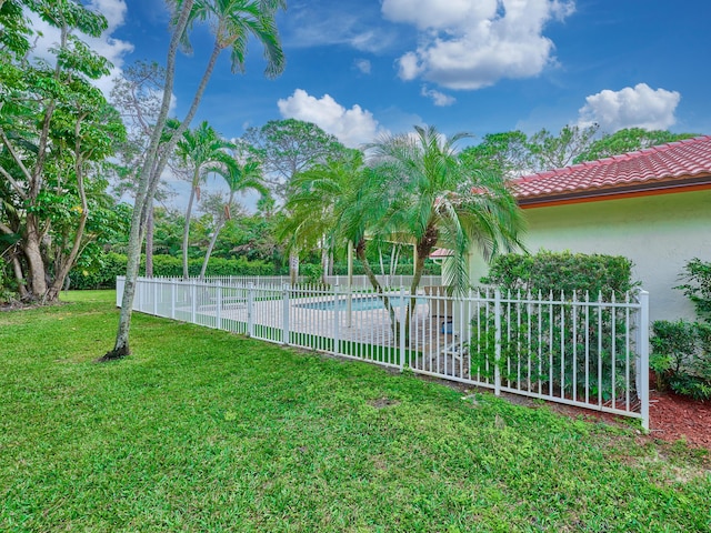 view of yard featuring a fenced in pool and fence