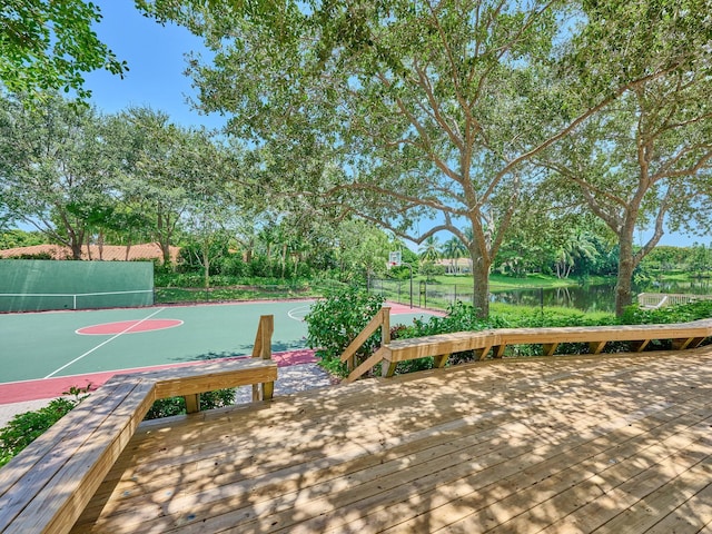 view of home's community featuring community basketball court and fence