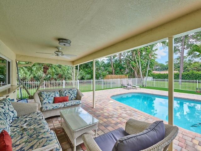 view of pool with a fenced in pool, outdoor lounge area, a ceiling fan, a patio area, and a fenced backyard